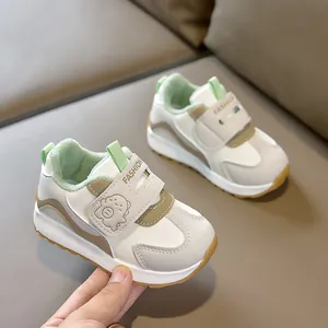 Detail view of toddler sneakers featuring plush lining, dinosaur strap, and non-slip rubber sole