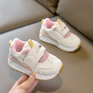 Detail of toddler sneaker featuring warm pink fleece lining and secure velcro strap closure