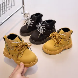 Detail of kids yellow and black boots with knit collars and non-slip soles