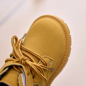 Close-up of durable yellow nubuck leather kids boots showing detailed stitching and laces