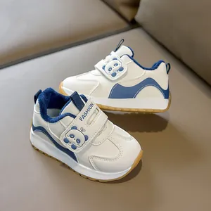 Detail of warm blue plush lining and cute panda velcro strap on white kids' sneaker
