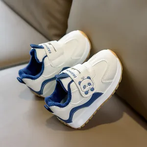 Detail of baby sneakers with panda patch, velcro strap and warm fleece lining