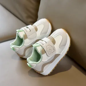Detail of warm winter baby sneakers with plush lining and cute dinosaur velcro strap