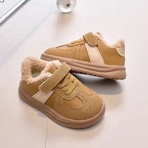 Close-up of children's warm ginger winter sneakers featuring plush lining and velcro strap