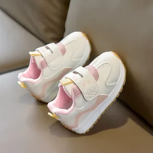 Detail of warm pink fleece lining and velcro strap on toddler non-slip athletic shoes