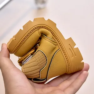 Detail showing the flexible sole of children's yellow boots with non-slip rubber texture