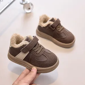 Detail of kids winter fleece-lined sneaker featuring velcro strap and brown suede texture