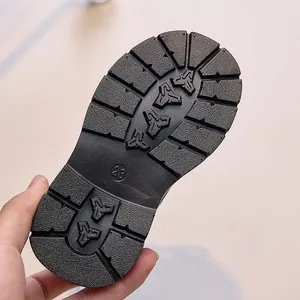 Close-up of non-slip rubber sole for kids boots featuring size 23 engraved tread pattern