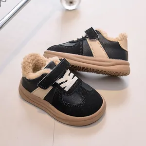 Close-up of children's winter sneakers showing plush fleece lining and non-slip rubber soles
