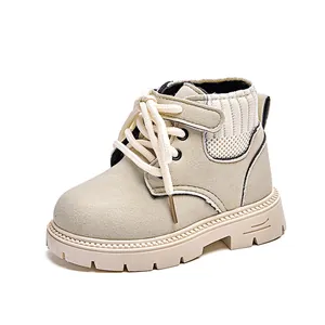 Detail of beige suede kids boot with knitted collar and adjustable velcro strap