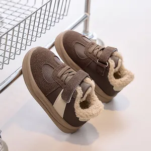 Detail of warm fleece lining and brown suede texture on children's winter sneakers