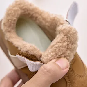 Detail of soft plush faux shearling lining inside brown winter boots for kids