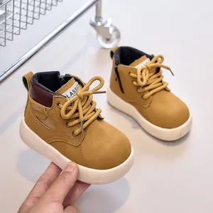Close-up of kids yellow leather martin boots with side zipper and white rubber sole
