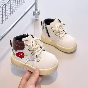 Detail of baby boots showing side zipper, thick rubber sole, and printed heart motif