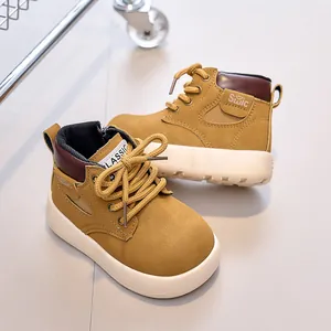 Detail of yellow toddler boots showing high-top leather finish and thick white non-slip sole