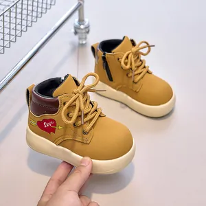 Close-up of yellow children's martin boots with heart print and side zipper detail