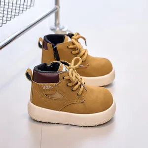 Close-up of kids' khaki leather boots with anti-slip thick soles and side zipper
