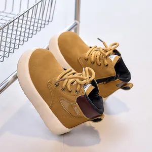 Detail view of mustard yellow kids boots with side zippers and non-slip platform soles