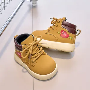 Detail of yellow kids martin boots with red heart embroidery and thick anti-slip sole