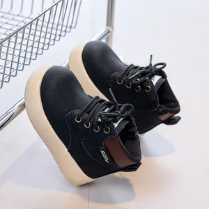 Detailed macro view of black pebbled leather and soft thick sole on kids martin boots