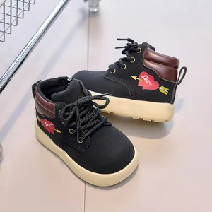 Detail view of children's black high-top boots with red love heart and side zipper