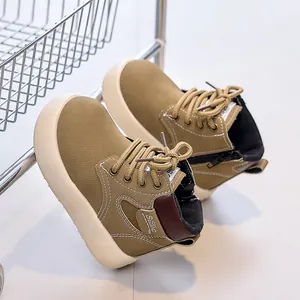Detailed view of kids' leather boots showing the textured upper and cream thick sole