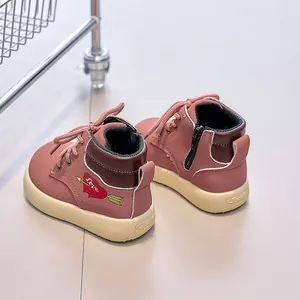 Detail of pink kids ankle boots with heart embroidery and side zipper closure