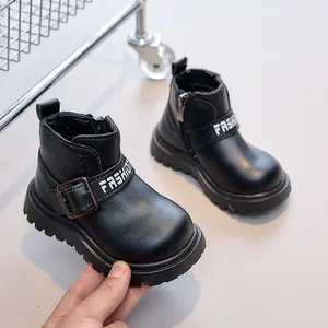 Detail of children black leather boots showing side zipper and thick non-slip rubber sole