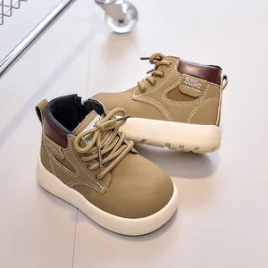 Detail view of khaki leather kids boots with non-slip thick soles and side zippers