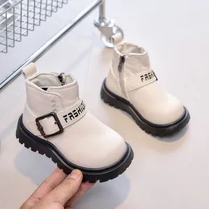 Detail of off-white kids leather boots featuring side zipper and buckle with FASHION text