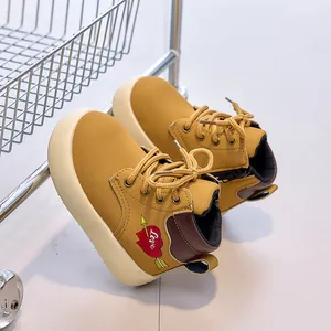 Detail of kids yellow martin boots with arrow heart embroidery and side zipper