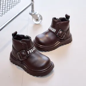 Detail of dark brown leather kids boots with side zipper and durable thick non-slip sole