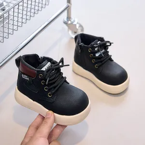 Detail view of children black leather boots with side zipper and thick white non-slip sole