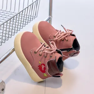 Detail of pink girls' leather boots with heart embroidery and stylish rubber sole