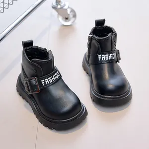 Close-up of black children boots with side zipper and thick anti-slip rubber sole