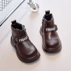 Detail of dark brown children boots with side zipper and FASHION metal buckle strap
