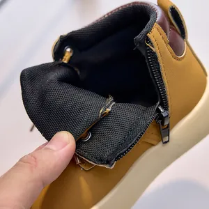 Detailed close-up of kids yellow boots featuring side zipper and breathable mesh lining
