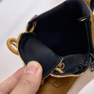 Detail of wheat yellow leather kids boot featuring side zipper and mesh lining