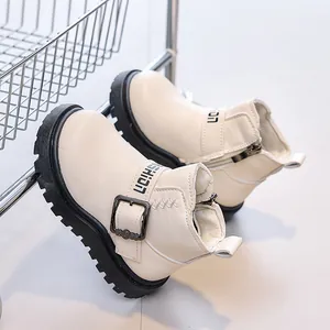 Close-up of beige leather kids boots featuring side zipper and metal buckle detail