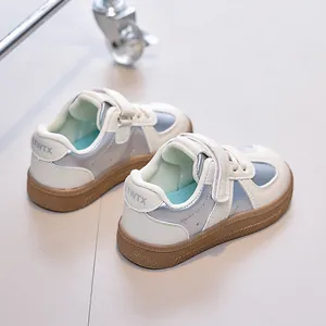 Détail de baskets pour enfants avec accents métalliques argentés et semelle gomme antidérapante