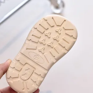 Detailed macro view of the anti-slip rubber sole with size 23 marking on kids boots