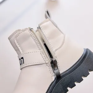 Detail of child's cream boot showing smooth side zipper and premium stitching quality