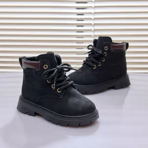 Detail of black children's martin boots with golden eyelets and non-slip rubber soles