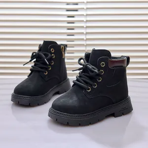 Detail view of black kids boots showing lacing, gold eyelets and side zipper