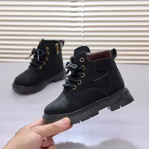 Detail of black matte toddler martin boots featuring a side zipper and thick rubber sole