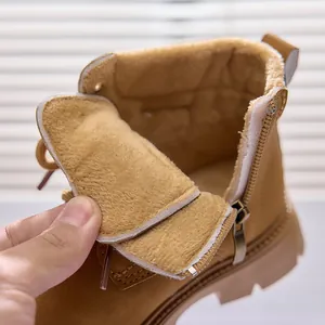 Detailed view of the thick warm faux fur lining inside kids yellow martin boots