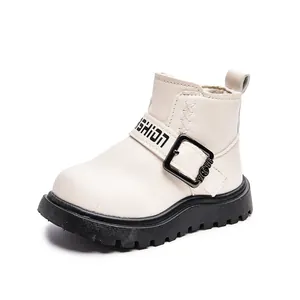 Kids cream ankle boots with black fashion strap and durable thick rubber soles