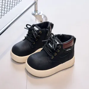 Kids black leather boots with textured finish and thick off-white non-slip soles