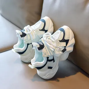 Detail of breathable mesh upper and thick non-slip sole on white kids sneakers