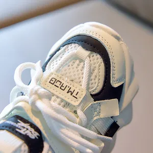 Detailed close-up of breathable mesh fabric and fine stitching on children sports shoes
